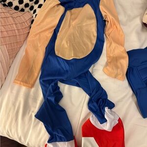 Blue and Beige Costume with Red and White Shoes